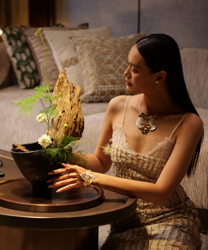 A guest arranging an ikebana composition in the living room
